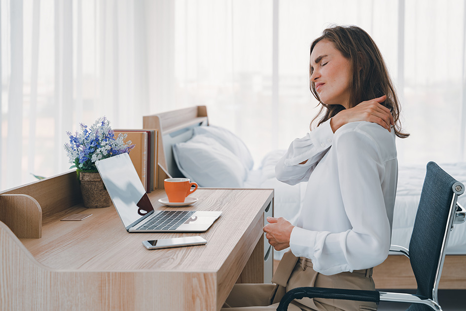 a seated woman massages her painful neck